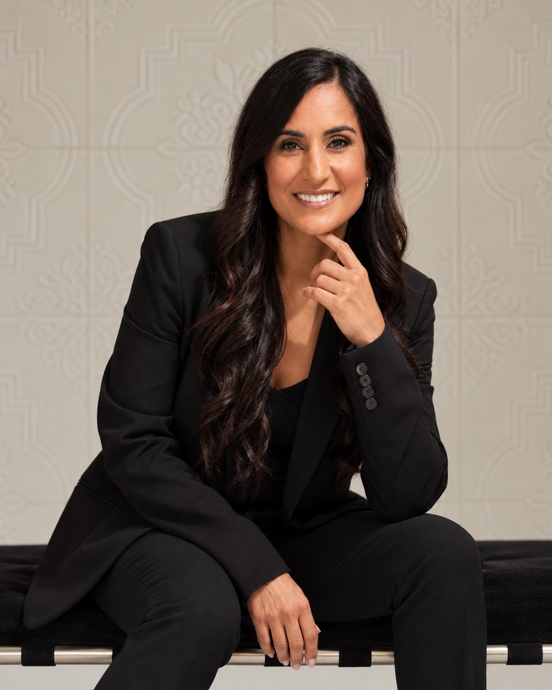 Dr. Remina Panjwani, seated in a black suit
